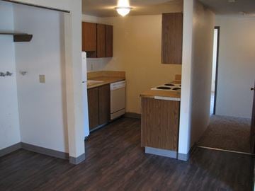 Kennewick apartment for rent - A kitchen with wooden cabinets and a white refrigerator.