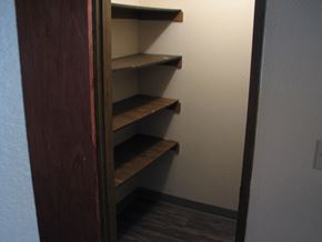 Kennewick apartment for rent - A small closet with shelves and a door.