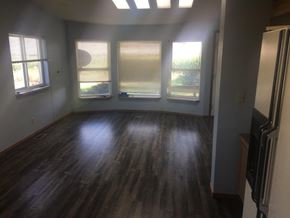 Prosser house for rent - A room with wooden floors and three windows.