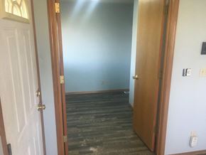 Prosser house for rent - A room with a wooden floor and a white door.