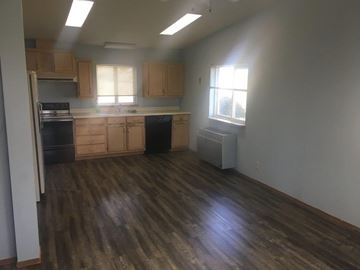 Prosser house for rent - A kitchen with wooden floors and cabinets.