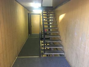 Pasco apartment for rent - A staircase with a black railing and steps leading to a door.