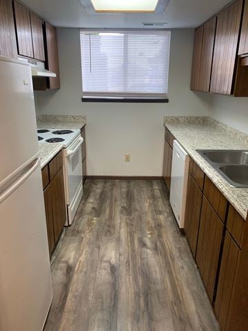 Kennewick apartment for rent - A kitchen with white appliances and wooden floors.