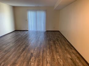 Kennewick apartment for rent - A room with wooden flooring and a window with blinds.
