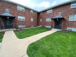 Omaha apartment for rent - A brick building with a black door and windows.