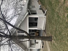 Omaha apartment for rent - a tree that has fallen on top of a house