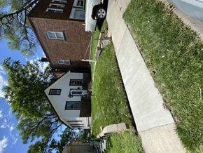 Omaha apartment for rent - a car is parked on the sidewalk in front of a house
