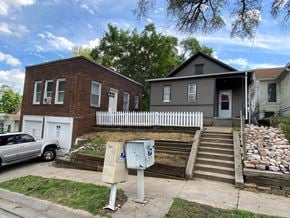 Omaha apartment for rent - a house and a truck parked in front of a sidewalk