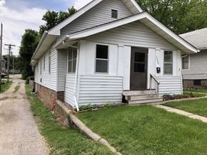 Omaha apartment for rent - a white house with a sidewalk in front of it