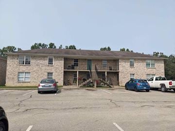 Shepherdsville apartment for rent - a large brick building with cars parked in front of it