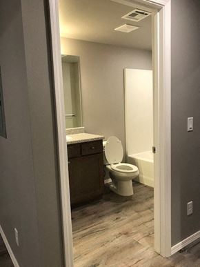 Siloam Springs apartment for rent - a bathroom with a toilet and a sink and a mirror