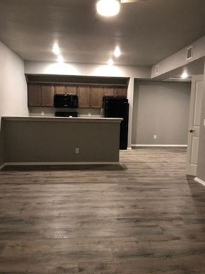 Siloam Springs apartment for rent - an empty living room with a kitchen and