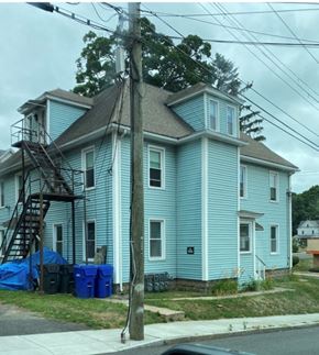 Manchester apartment for rent - a blue house on the corner of a street