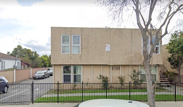 Pico Rivera apartment for rent - a building with a fence and cars parked in front of it