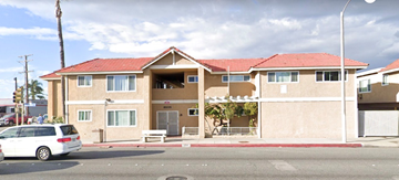 Bellflower apartment for rent - a building with a white car parked in front of it