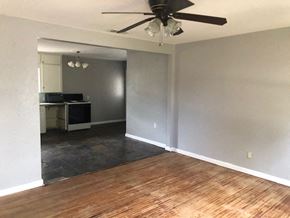Snyder house for rent - an empty living room with a ceiling fan