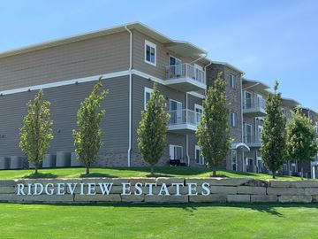 Kearney apartment for rent - a large apartment building with a sign in front of it