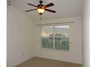 Orange Park house for rent - a bedroom with a ceiling fan and a window