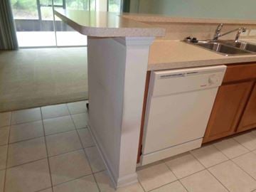 Orange Park house for rent - an island in a kitchen with a sink and a dishwasher