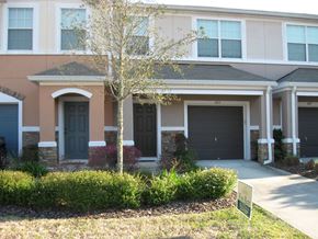 Orange Park house for rent - a house with black doors and a sidewalk in front of it