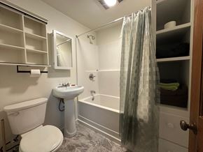 Sitka house for rent - A white bathroom with a toilet, sink, and bathtub.
