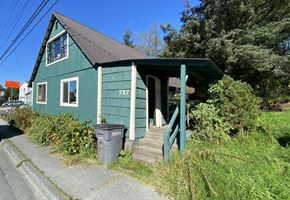 Sitka house for rent - A green house with the number 217 on it.