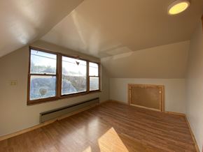 Sitka house for rent - A room with wooden floors and a large window.