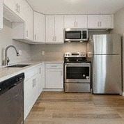 Tacoma apartment for rent - a kitchen with stainless steel appliances and white cabinets