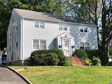 Port Washington apartment for rent - A house with a grey facade and a white door.
