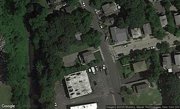 Port Washington apartment for rent - A satellite image shows a residential area with houses and a large parking lot.