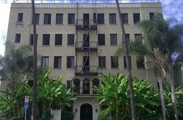 Los Angeles apartment for rent - an old building with palm trees in front of it
