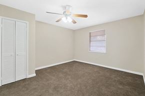 Slidell apartment for rent - an empty bedroom with a ceiling fan and a closet