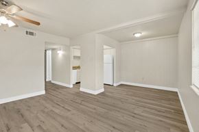 Slidell apartment for rent - an empty living room with white walls and wood floors