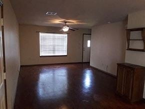 Stillwater house for rent - A room with a brown floor and a ceiling fan.
