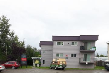 Chetwynd apartment for rent - a large apartment building with cars parked in front of it