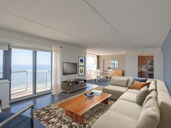 A living room with a large couch and a television.