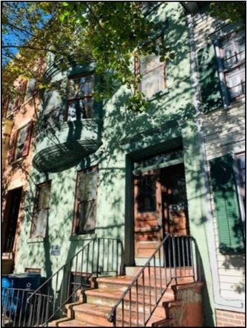 Albany apartment for rent - a house with stairs and a tree in front of it