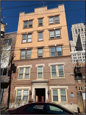 Albany apartment for rent - a tall brick building with a car in front of it