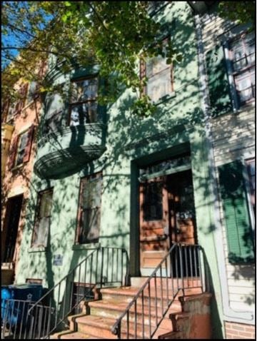 Albany apartment for rent - a house with stairs and a tree in front of it