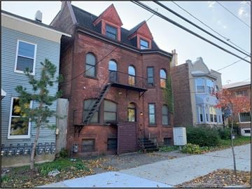Albany apartment for rent - the front of a brick house with a staircase