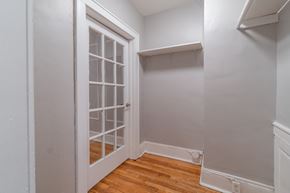 Albany apartment for rent - a bedroom with a door to a closet and a wooden floor