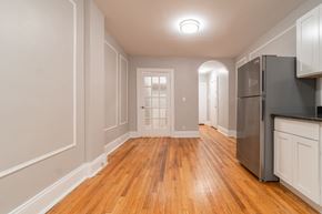 Albany apartment for rent - an empty kitchen and living room with wood floors and a refrigerator