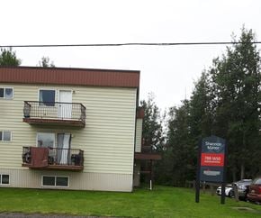 Chetwynd apartment for rent - a white house with a red sign in front of it