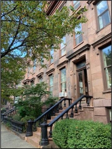 Albany apartment for rent - a building with stairs and a tree in front of it