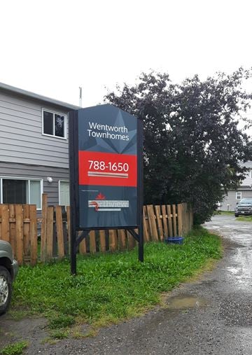Chetwynd apartment for rent - a sign sitting in front of a house