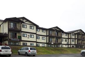Chetwynd apartment for rent - a large apartment building with cars parked in front of it