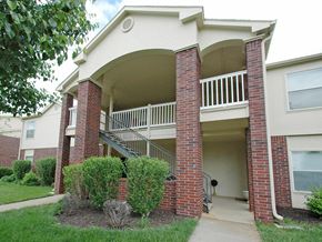 Grandview apartment for rent - an exterior view of a building with a porch and stairs
