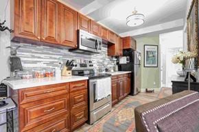 Oshawa apartment for rent - a kitchen with wooden cabinets and stainless steel appliances