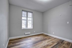 Oshawa apartment for rent - the master bedroom has a large window and hardwood floors