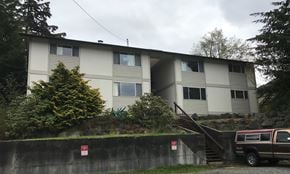 Sitka apartment for rent - an apartment building with a truck parked in front of it